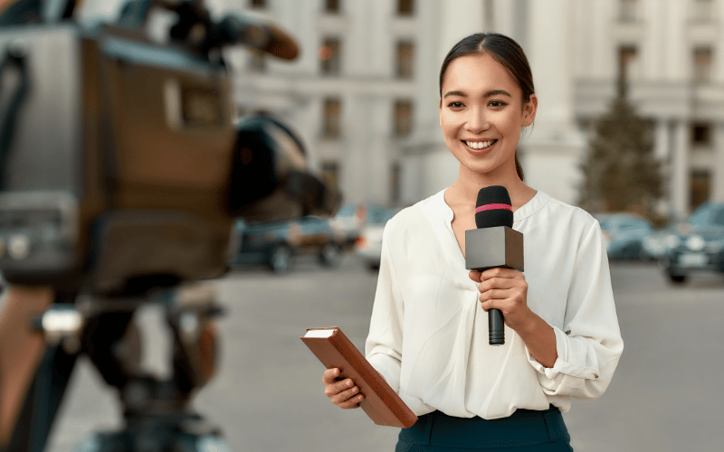 A confident news reporter presenting in front of a camera