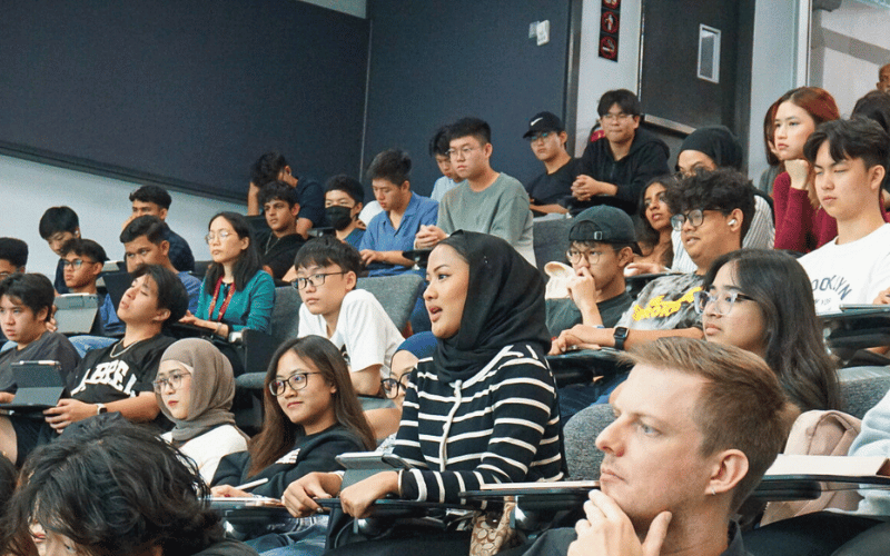 One student addressing a question among the crowd