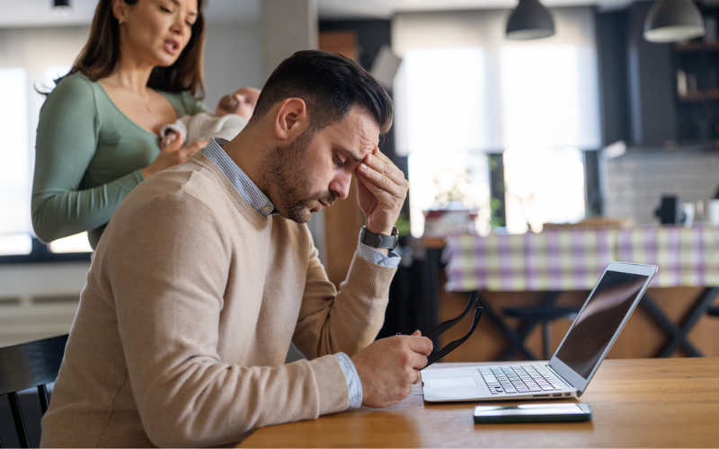 Man resting forehand in hand, appearing stressed