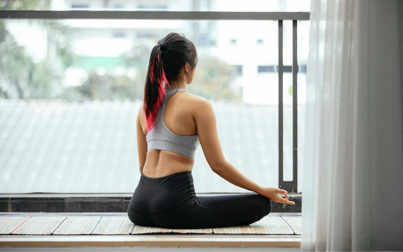 Woman sitting cross-legged, meditating
