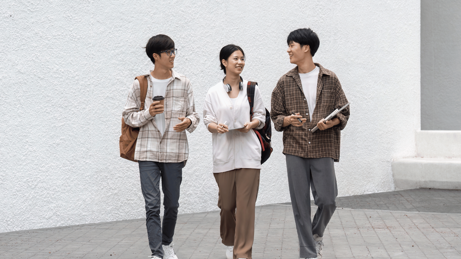 three students looking at each other
