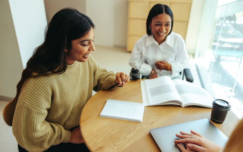 Two students engaging in a study session with another person