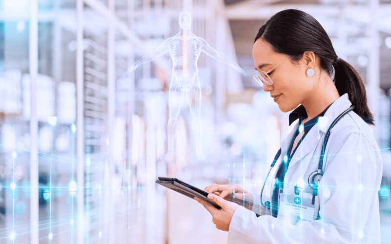 Doctor using a tablet in a data-rich environment with digital health graphics in the background.