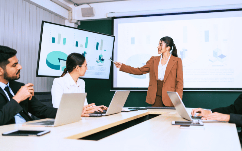 A confident lady presenting her data to the stakeholders