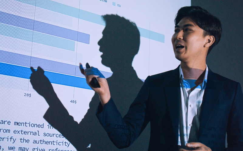 Male working professional presents his data findings