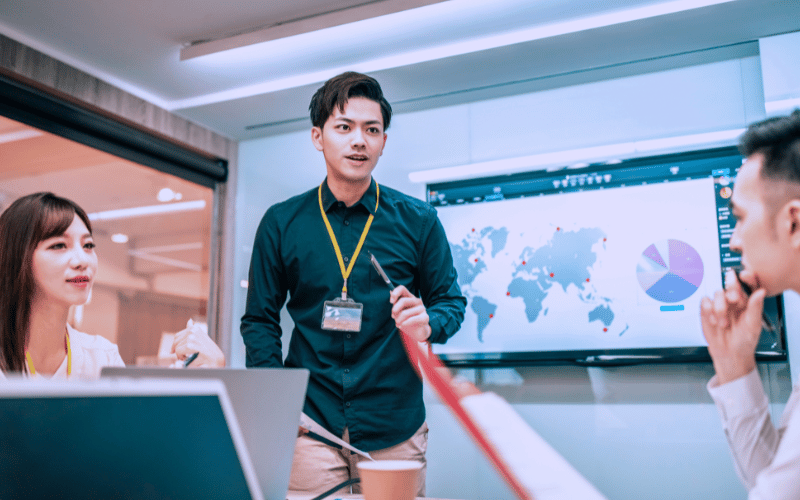 Male working professional presents in front of his stakeholders