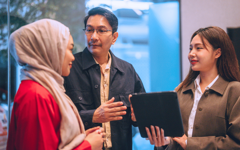 three adults discuss about work