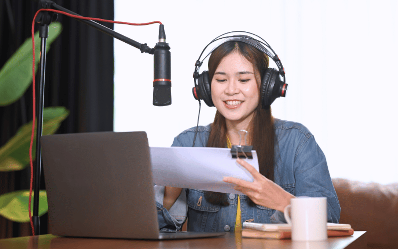 Woman doing voice recording while looking at script