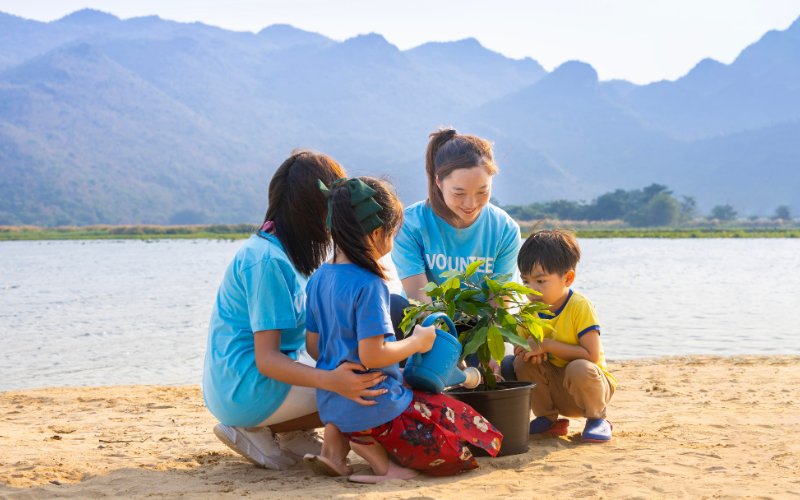 Lady looking at plant with kids