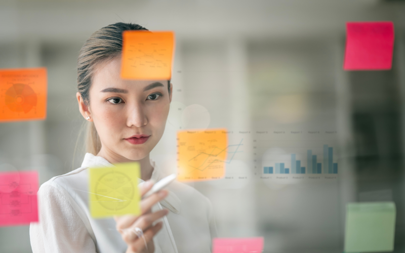 Woman looking at sticky notes