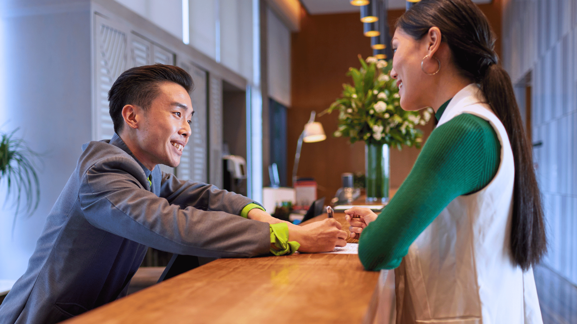 Hotel staff welcoming a lady guest with care
