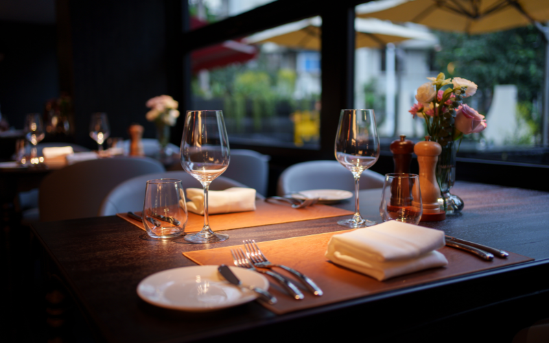 A softly lit restaurant table set for two