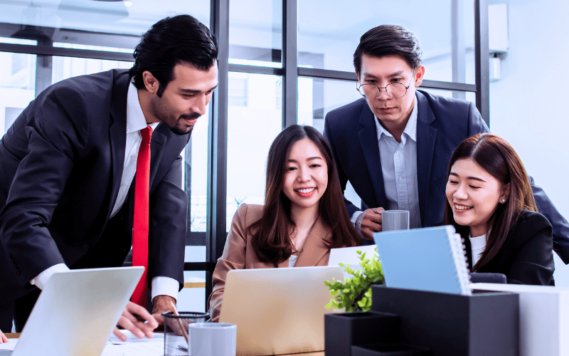 Five accounting co-workers having financial discussion over the laptop
