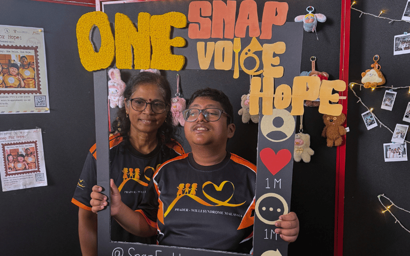 Parent and her PWS child took a picture together at Snap for Hope booth