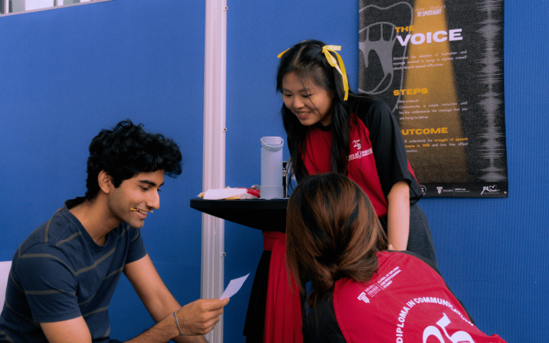 A Taylor's student participates in one of the sensory simulation experiences booth
