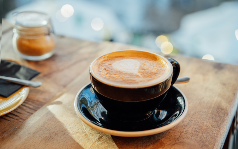 A cup of coffee sits on a table