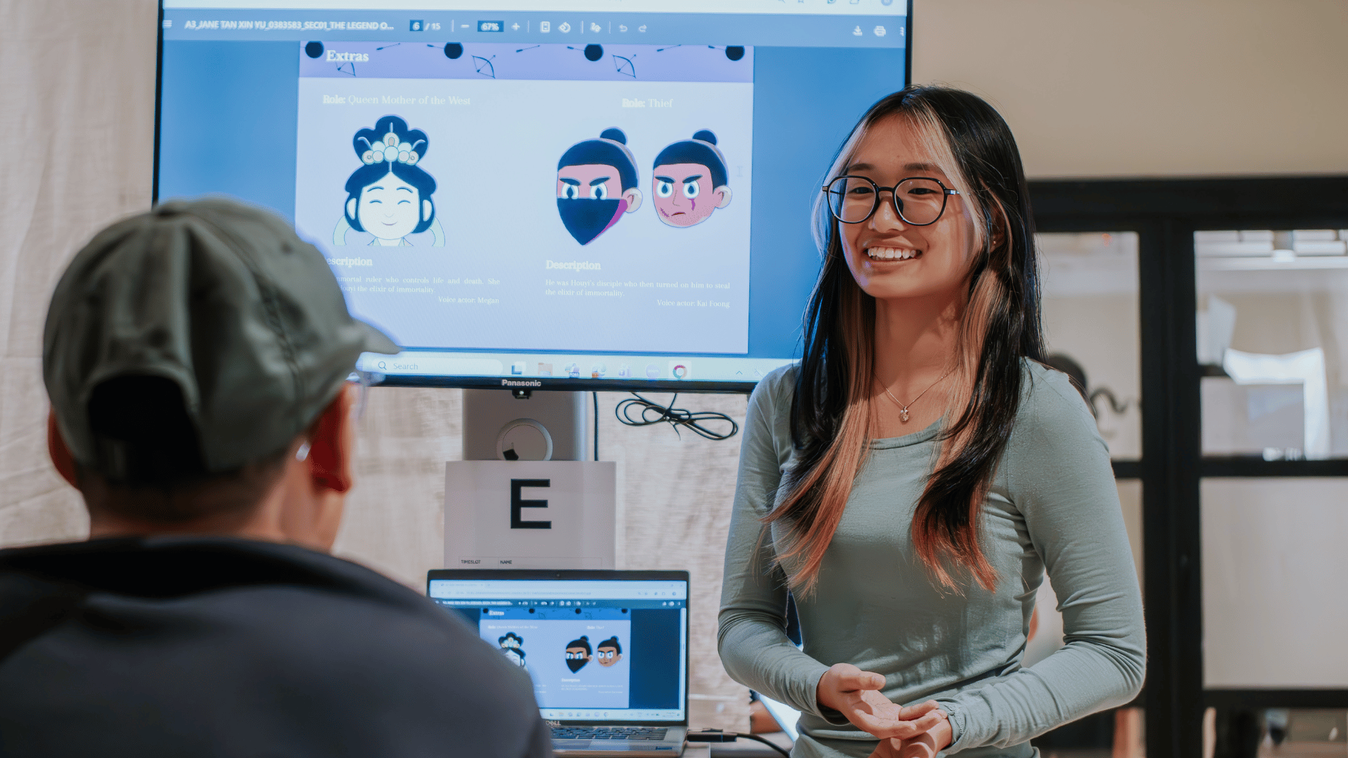 Student present illustration project on screen