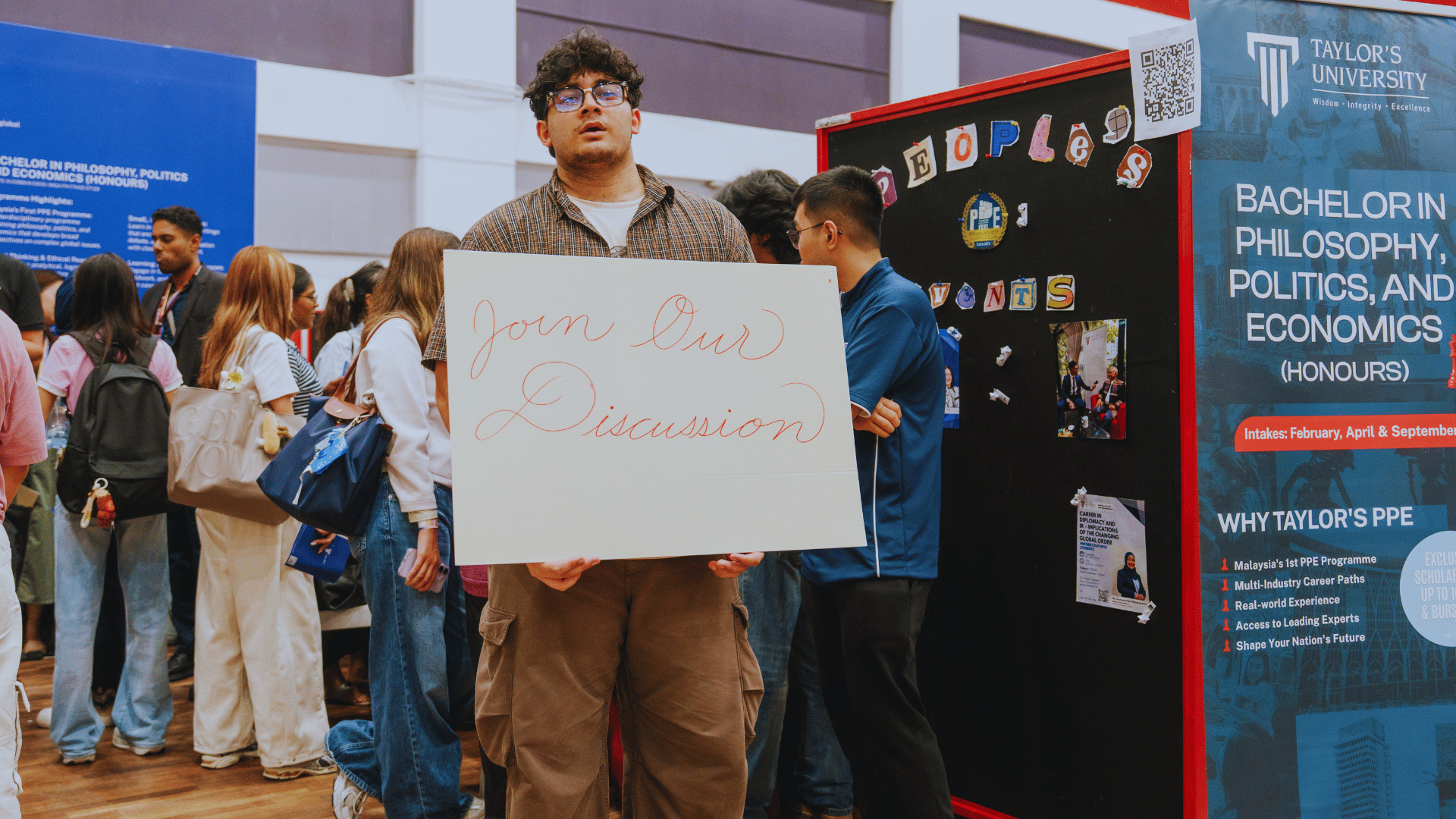 Guy holding a signage during Progression Fest 2026