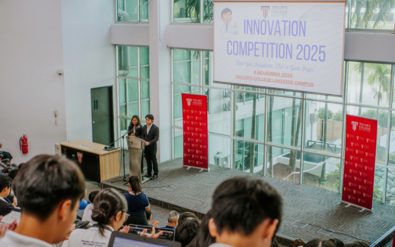 Two presenters at the Taylor's College Lakeside Campus for the Innovation Competition 2025, addressing an audience.