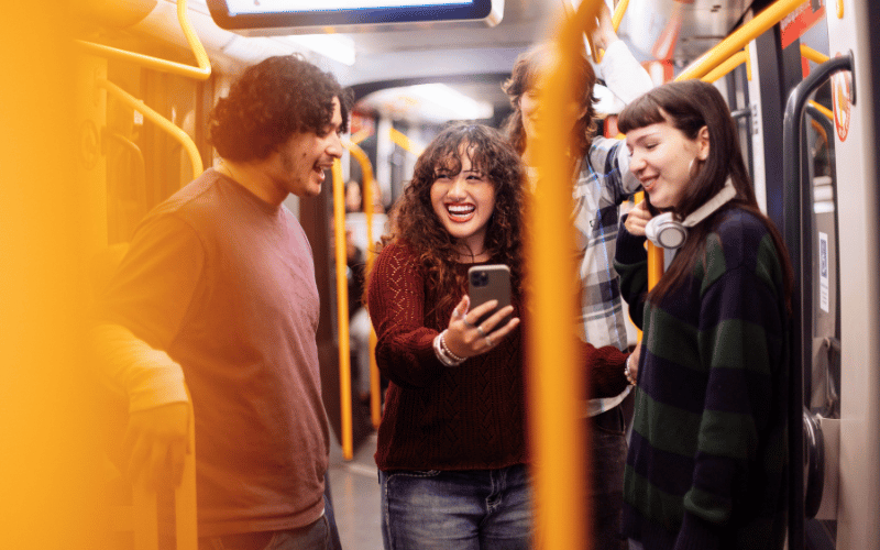 Diverse background of students chatting and networking in a railway station.