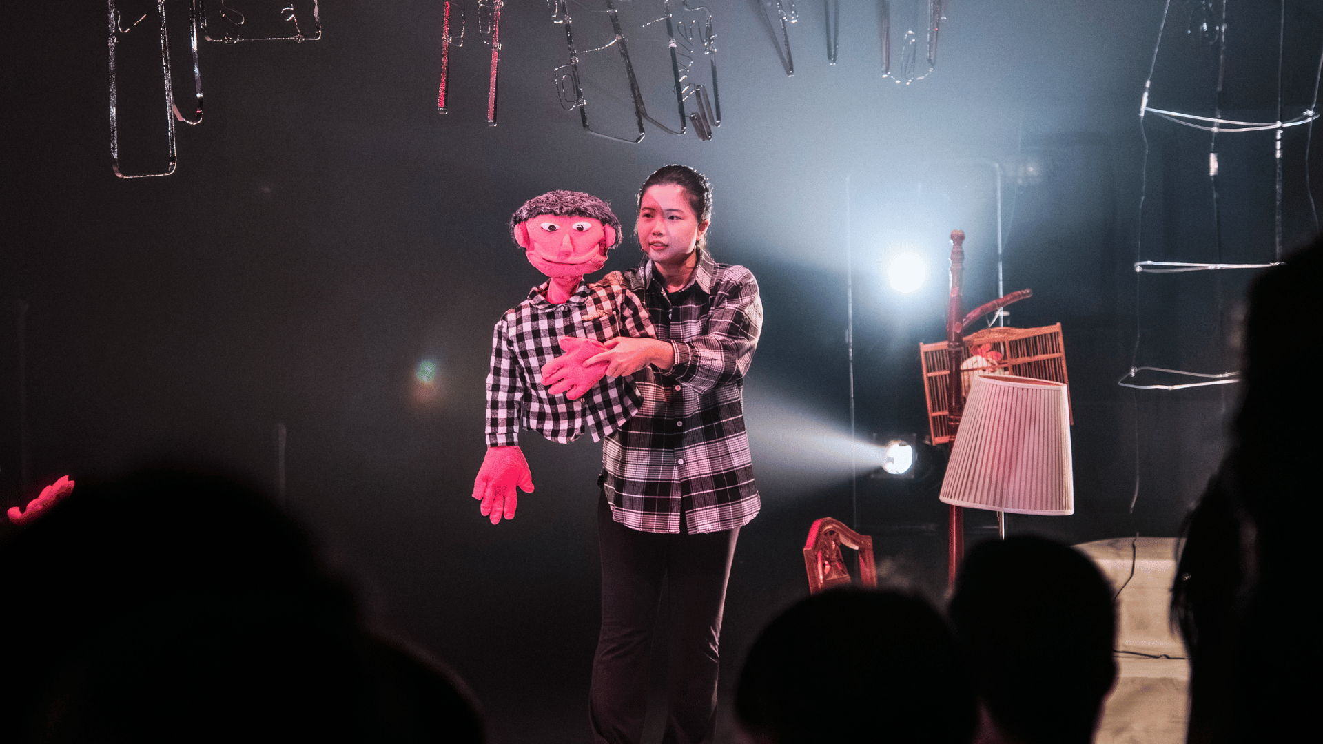 Student performing with a puppet in front of a crowd