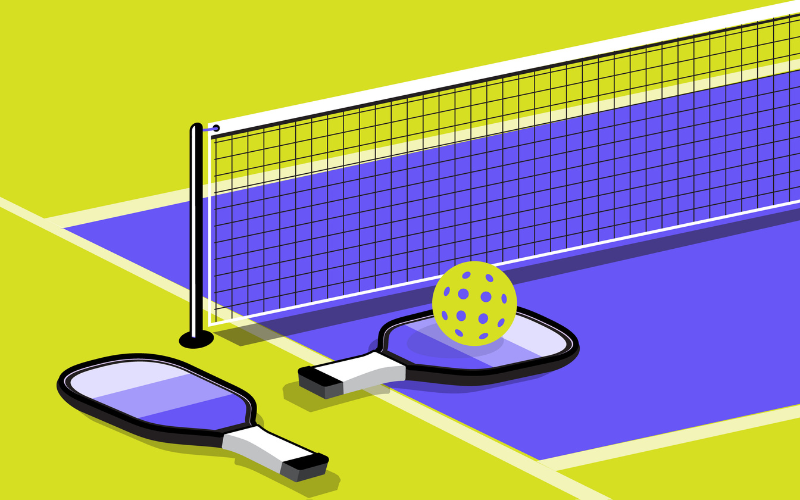 Pickleball paddles and ball beside a net on a court