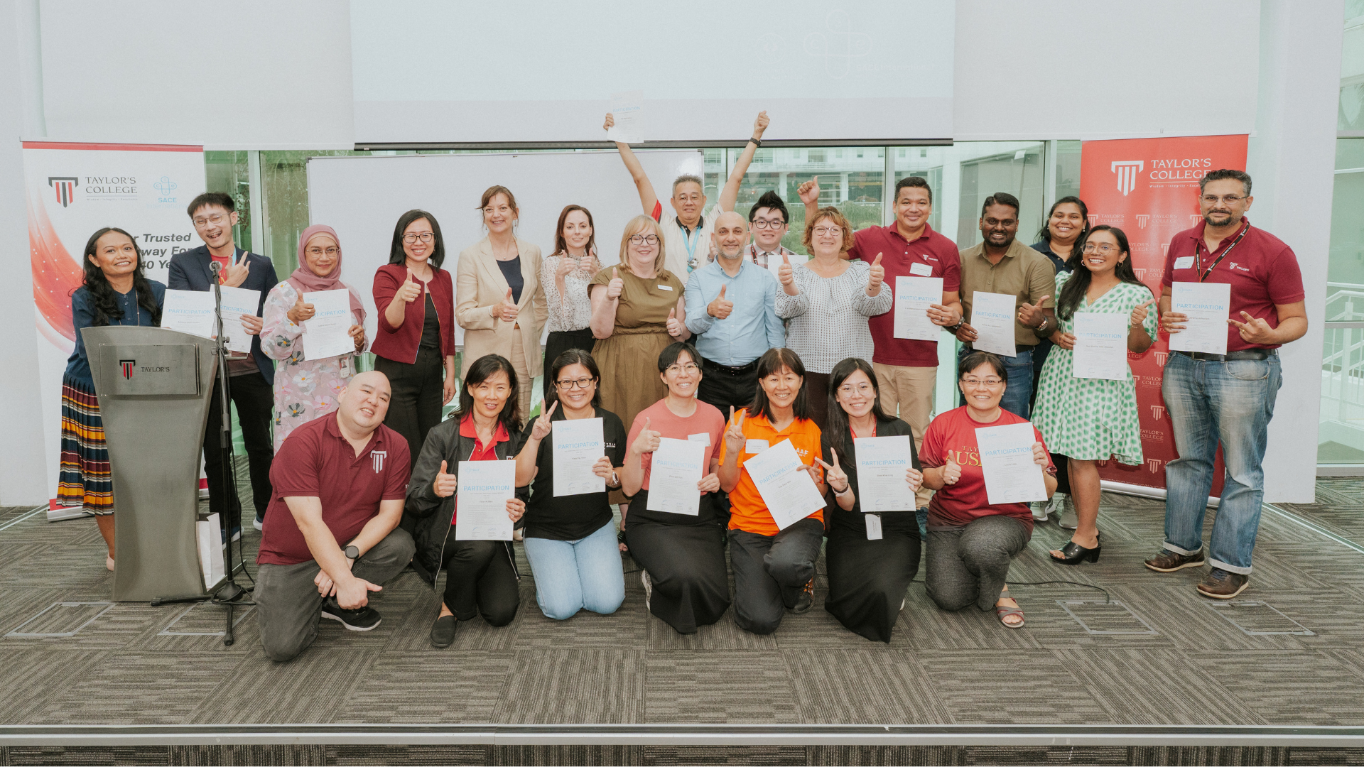 Group of lecturers and educators posing with certificates at a Taylor’s College workshop