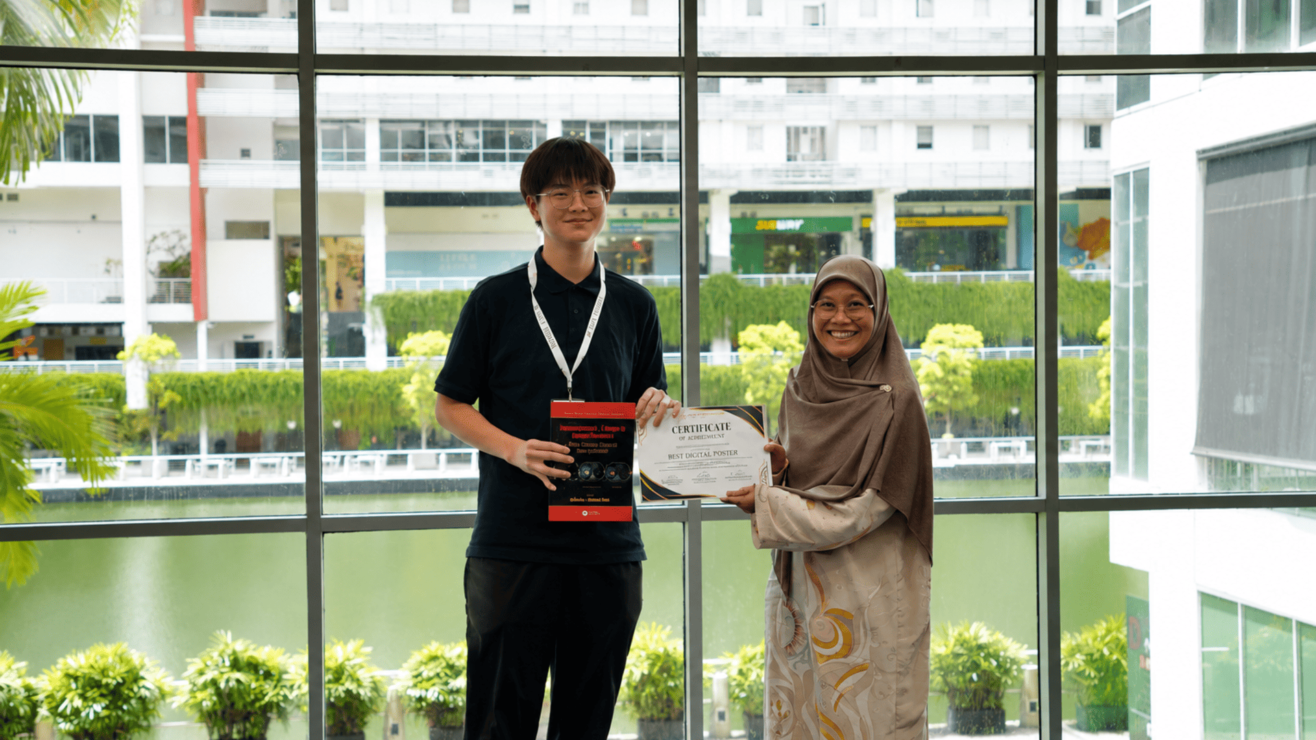 Jayden Wong Kah Ho posing with fellow chess players on stage at the Grand Asian Chess Championship
