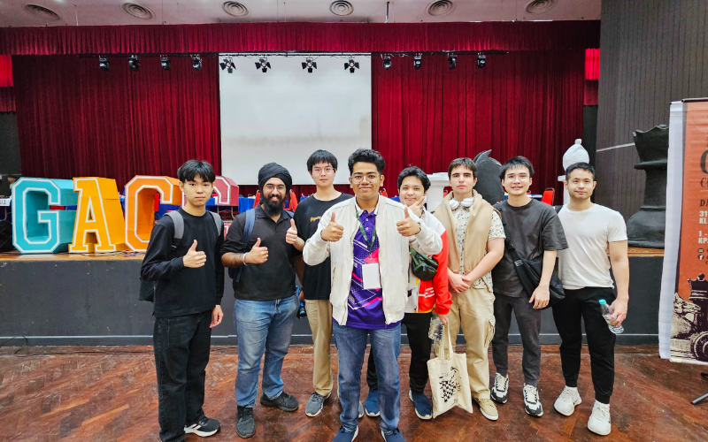 Jayden and fellow players celebrating on stage at the Grand Asian Chess Championship
