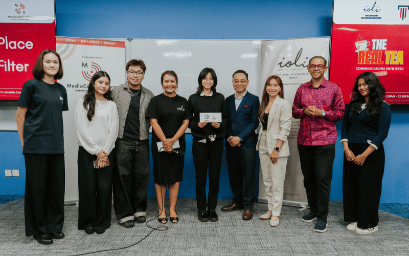 Eight people standing together for a group photo at The Real Tea event