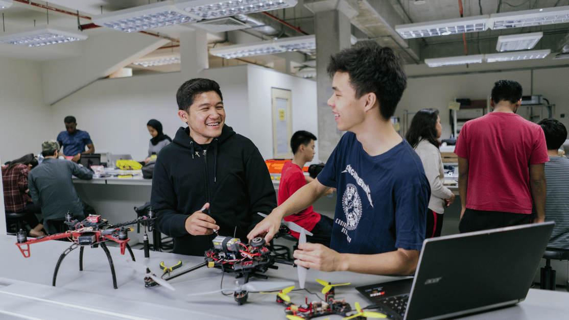 Two male students working on an engineering project together
