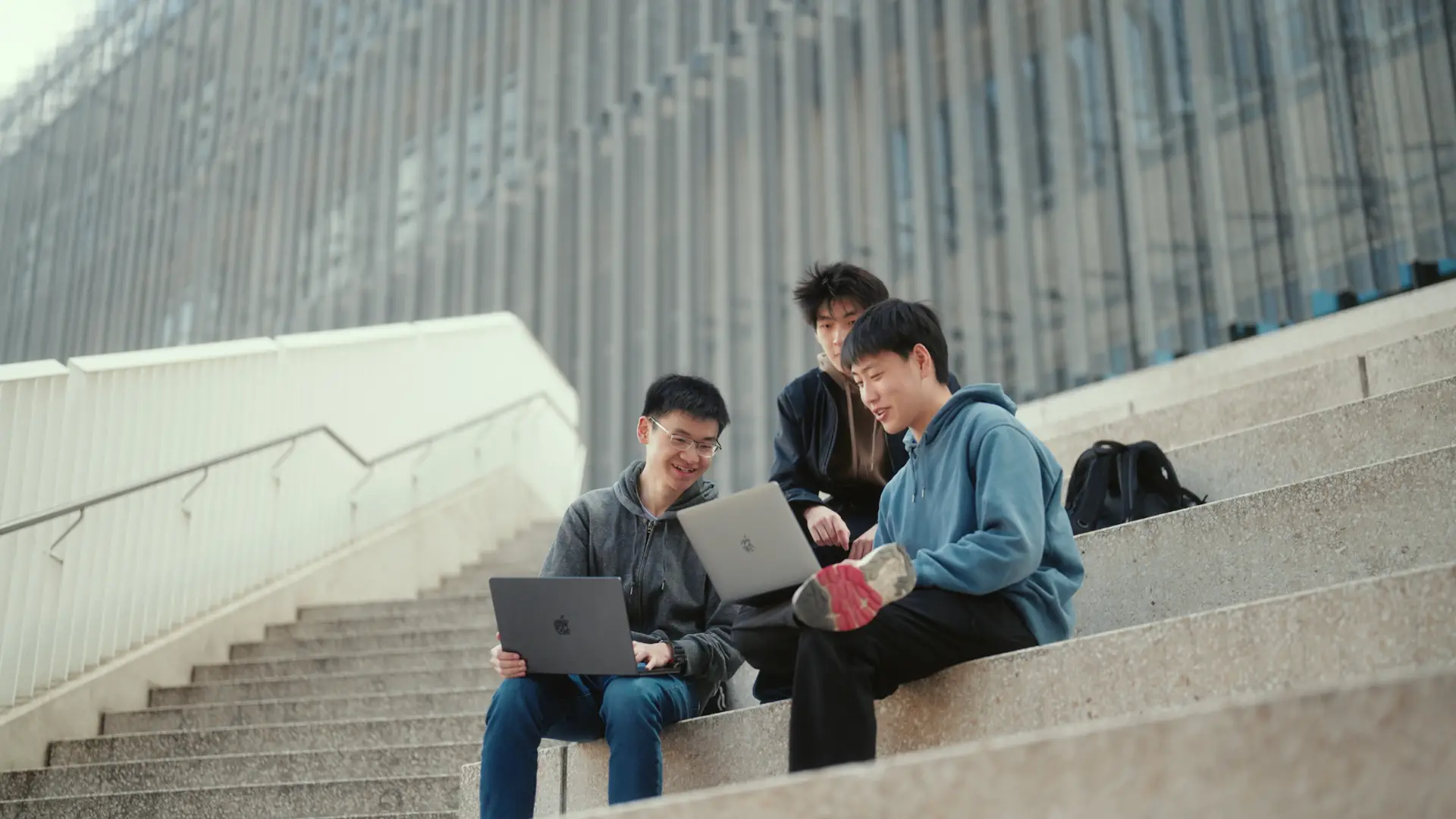 AUSMAT students sat down on the main stairs discussing about assignment