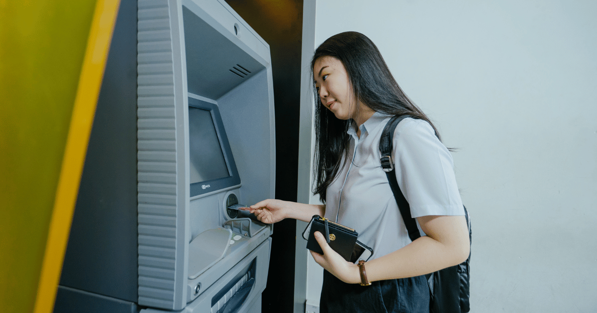 Student withdrawing money from ATM machine