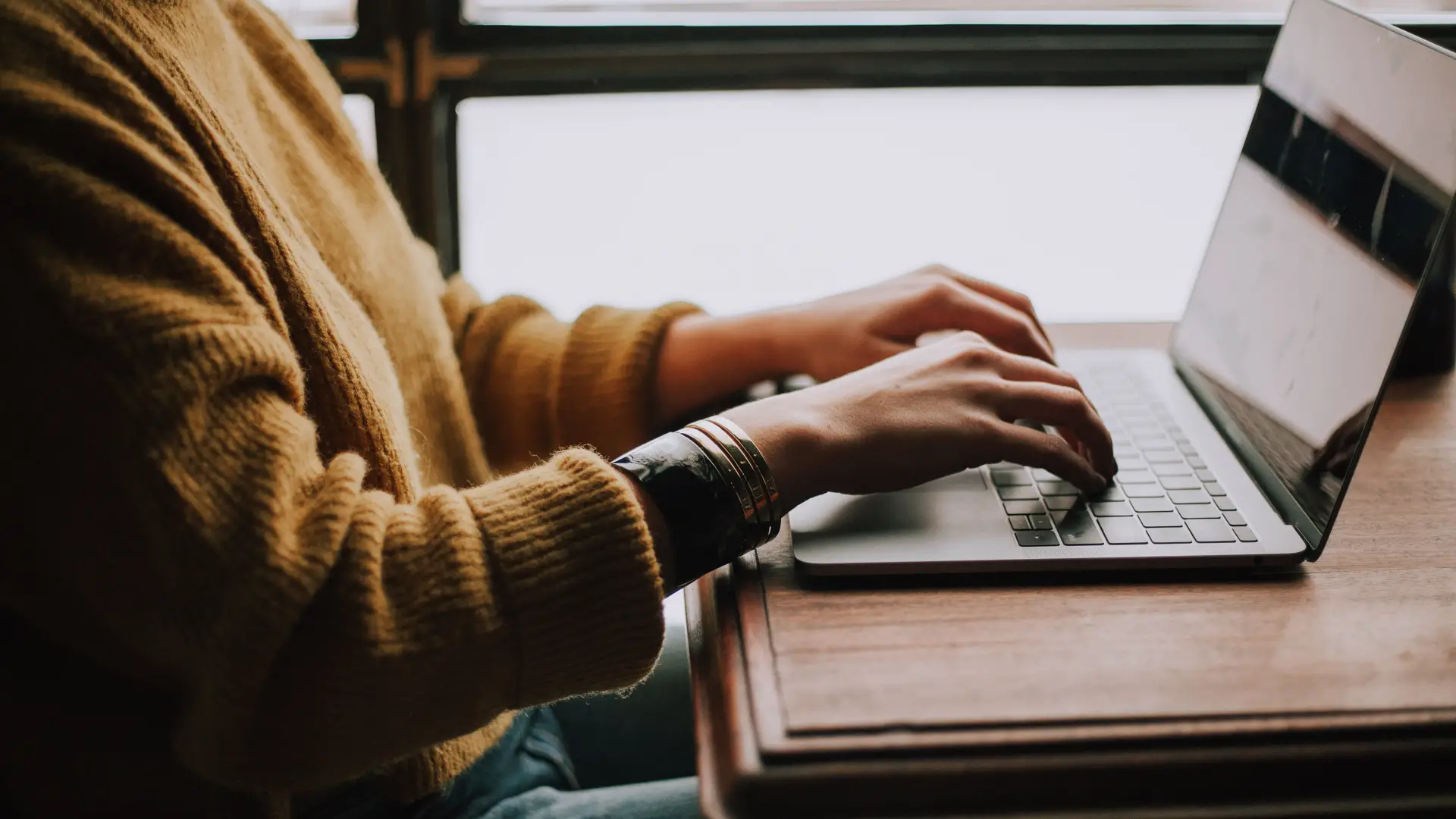 student using a laptop on a desk