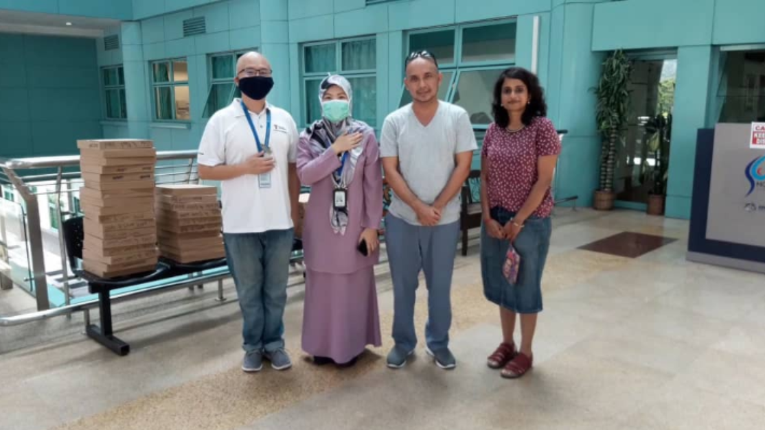 senior academics picture with hospital staff