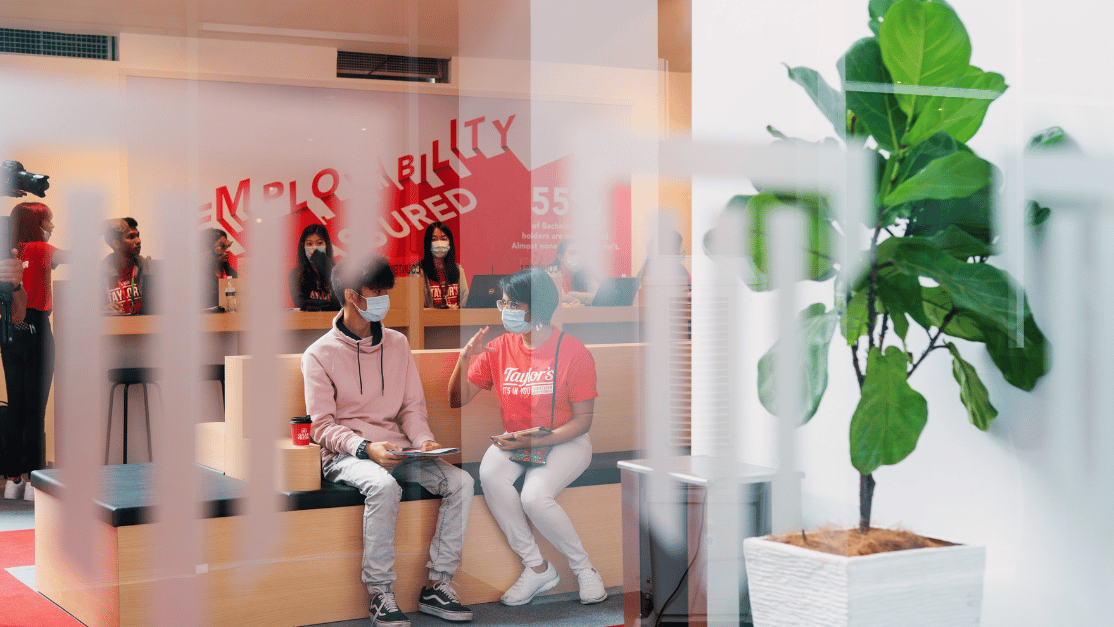 Adult is seen talking to a student