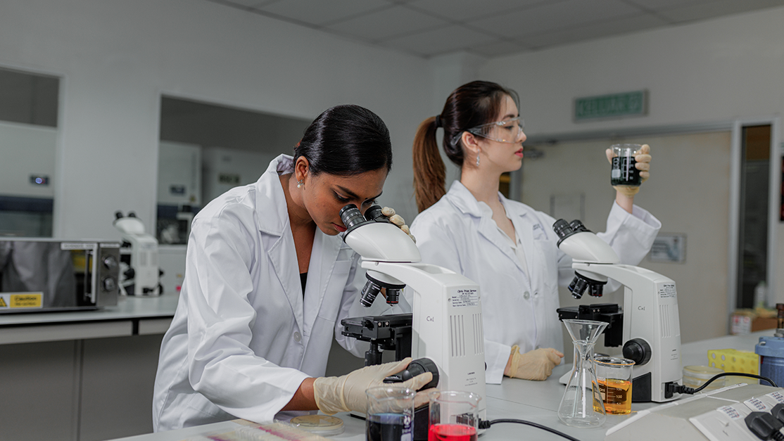 taylor's student using microscope