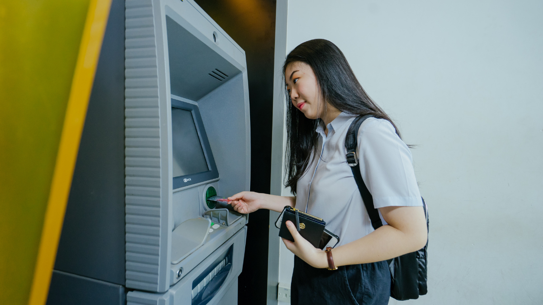 a girl using an atm