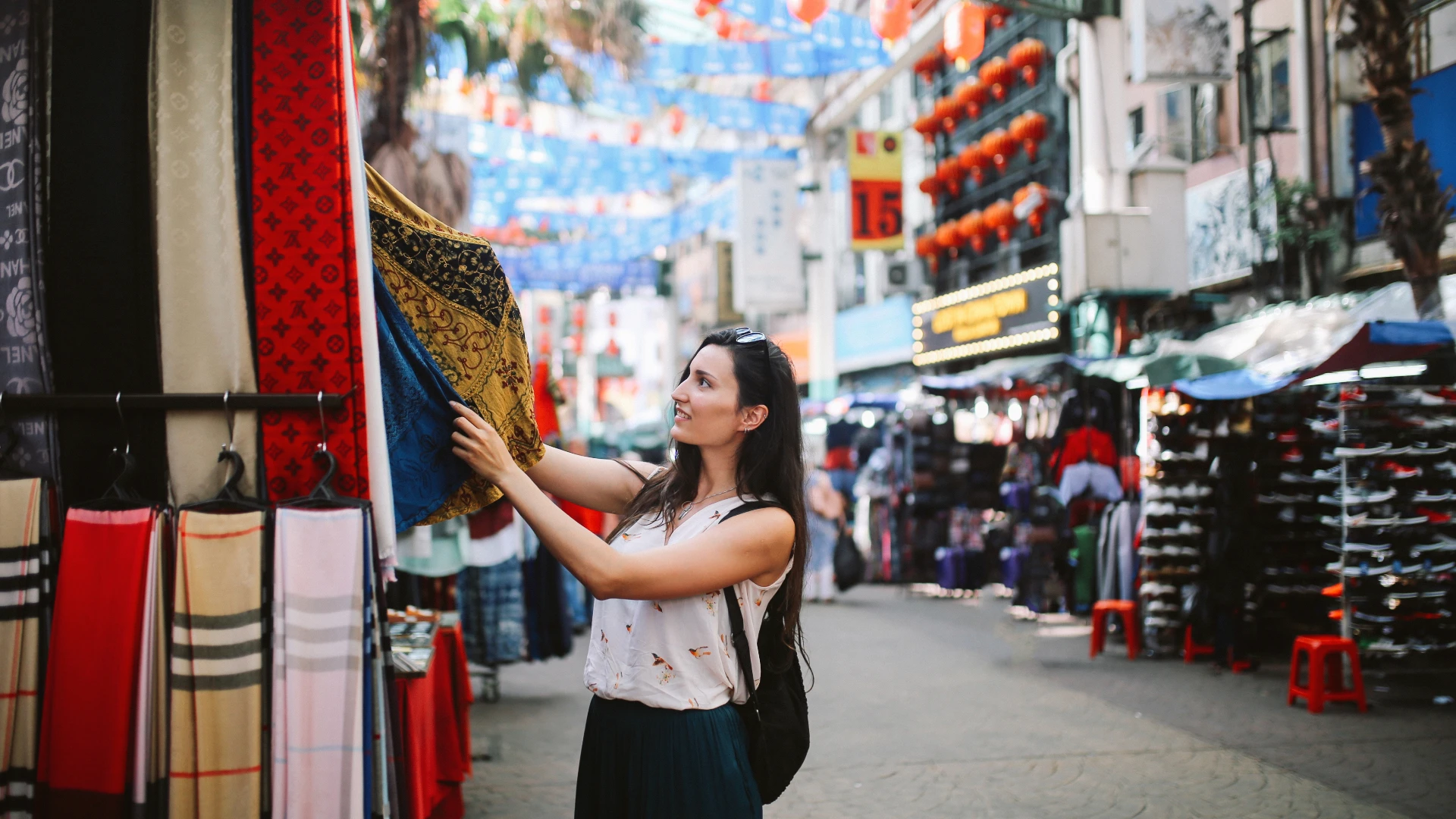 A woman picking out clothes from a local market