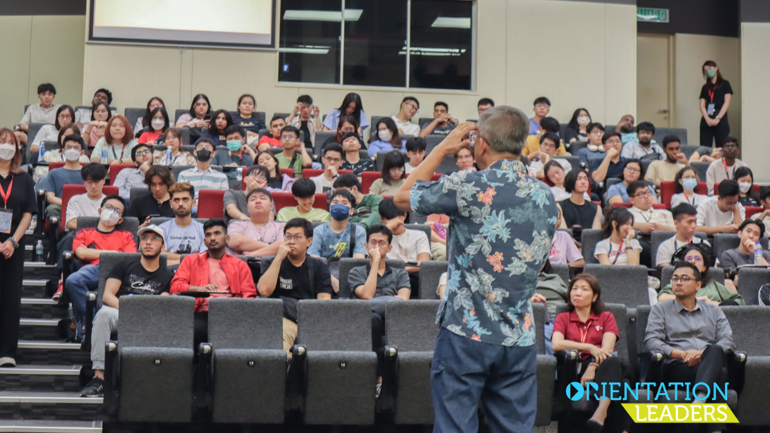 lecturer speaking to a group of students