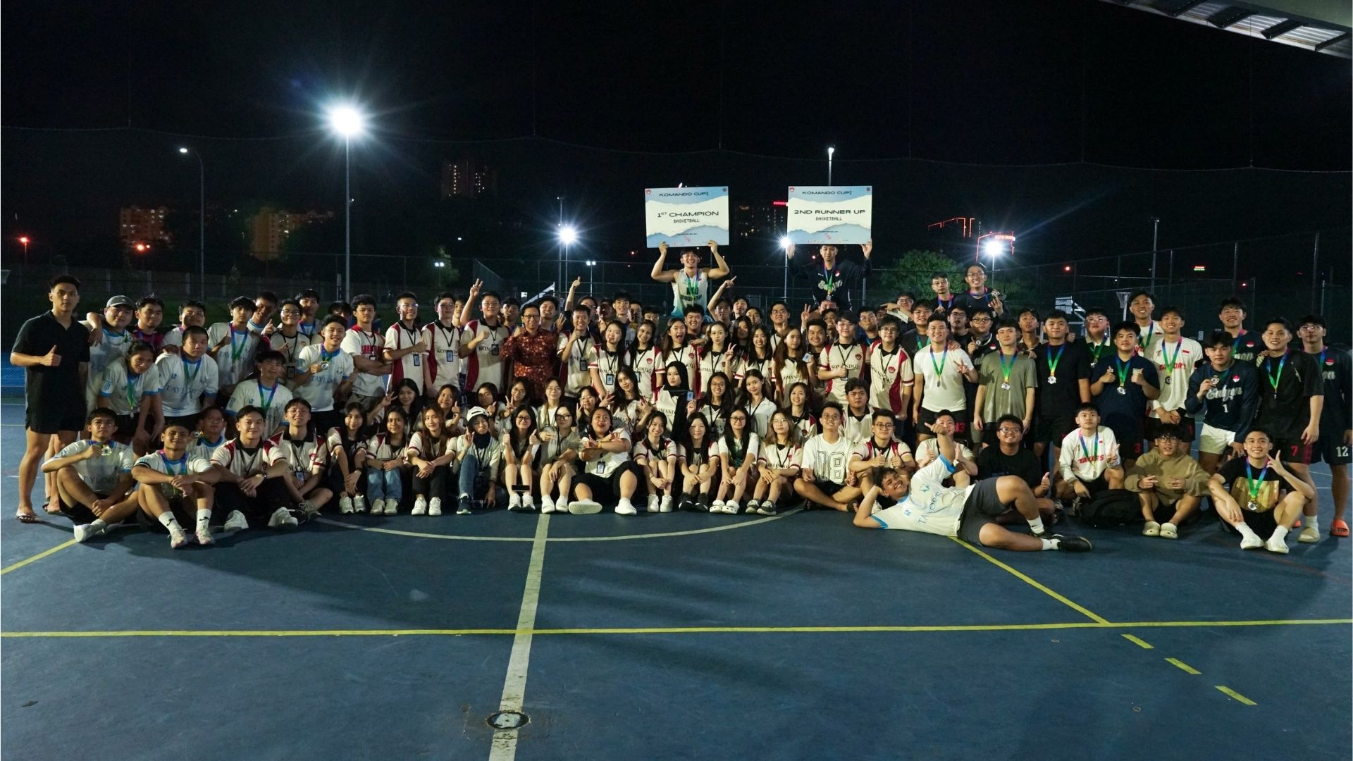 komando students posing in front of sports court