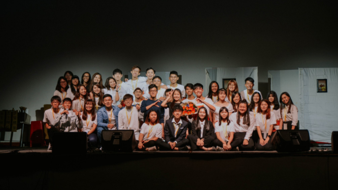 chinese society students group picture in a dark room