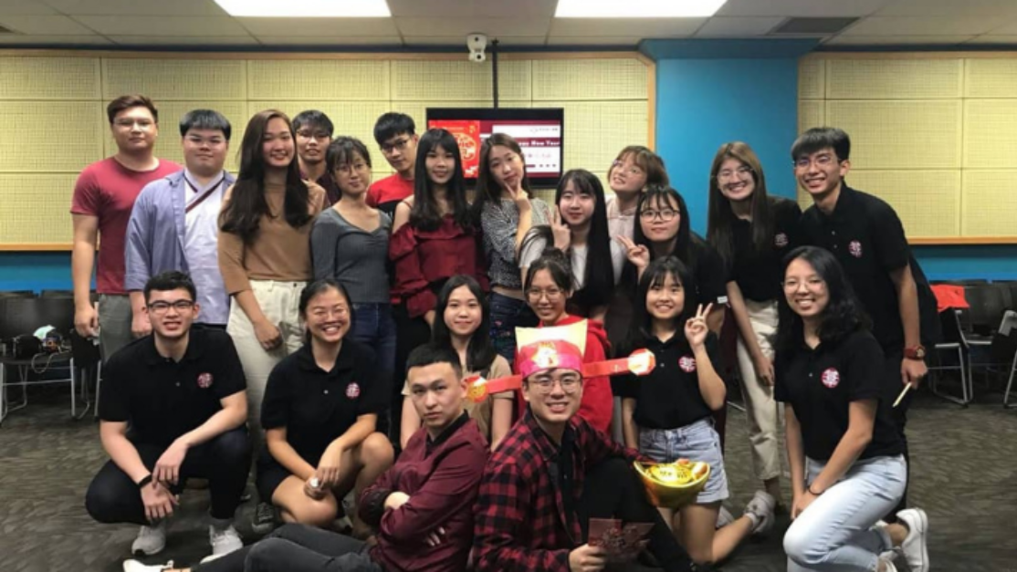 students posing for photo in a small classroom
