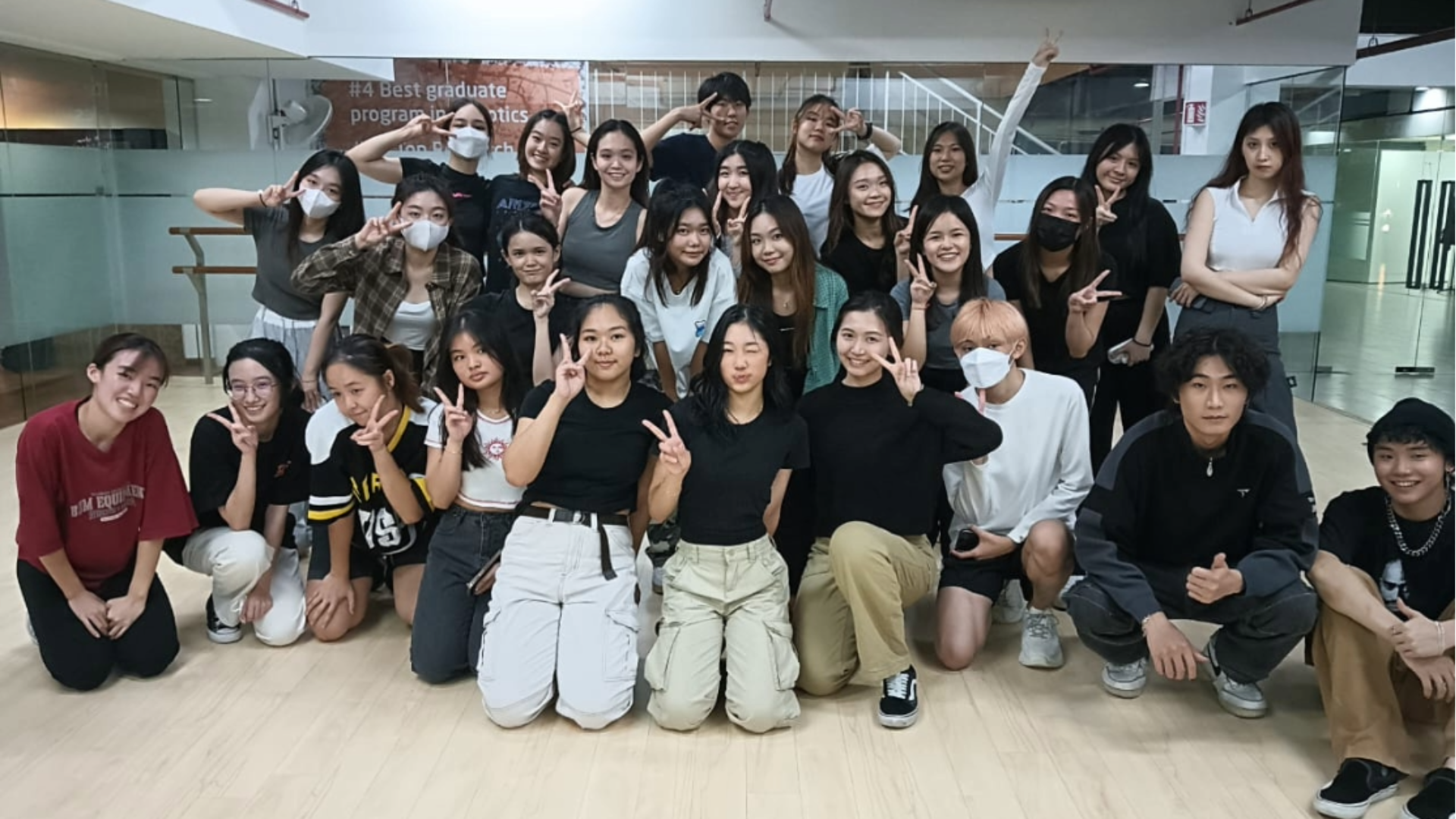 students in a photo pose in a dance studio