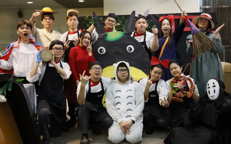 Young Chefs posing outside house