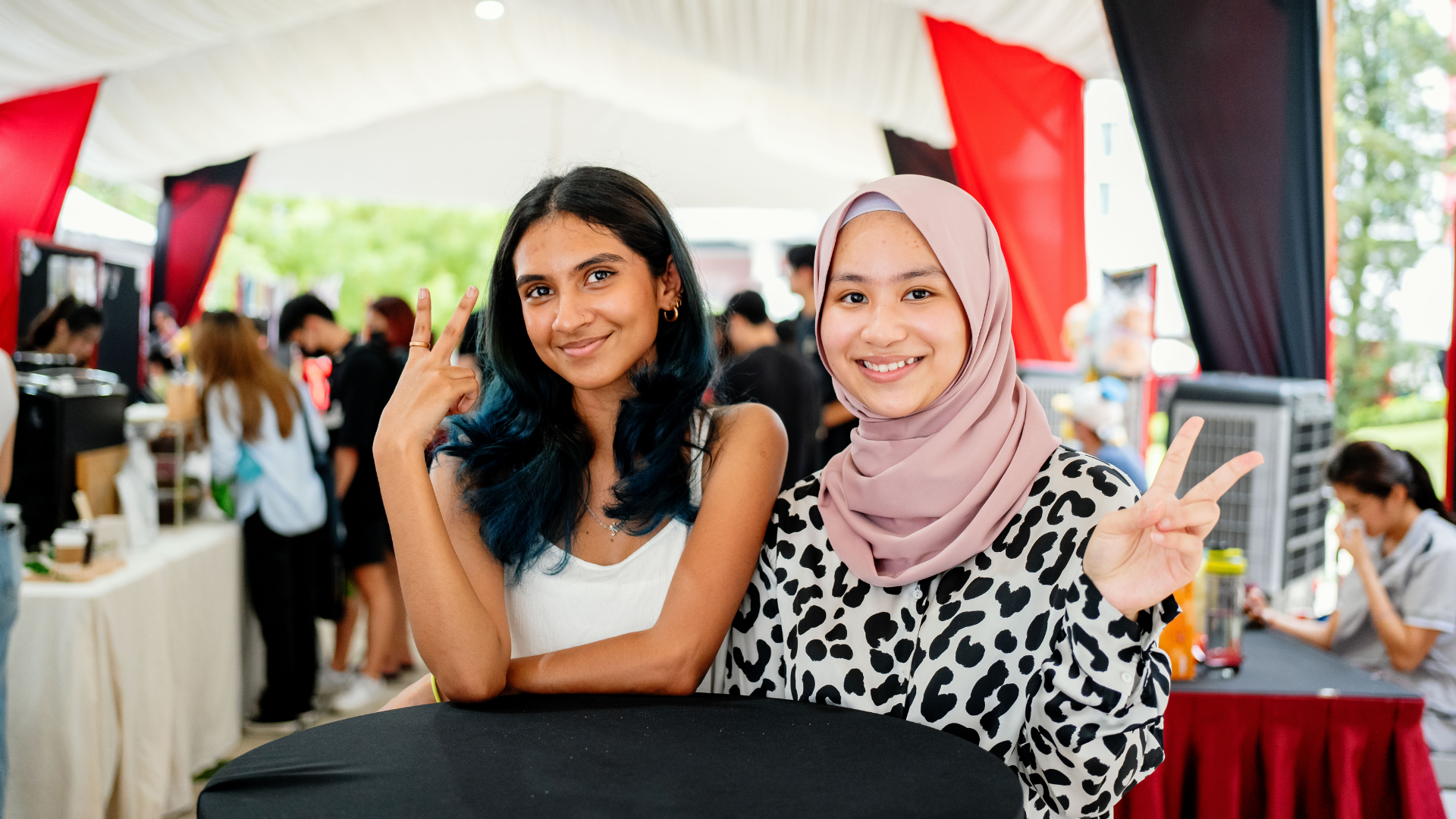 3 international students sitting on outdoor stairs