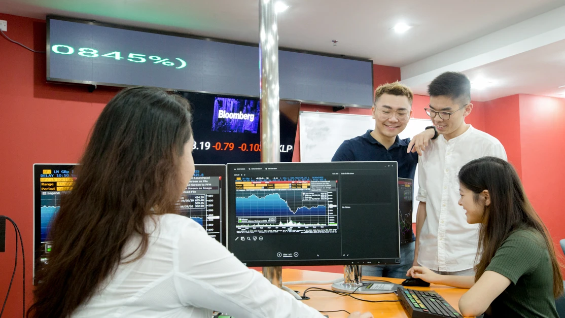 students working on a bloomberg terminal